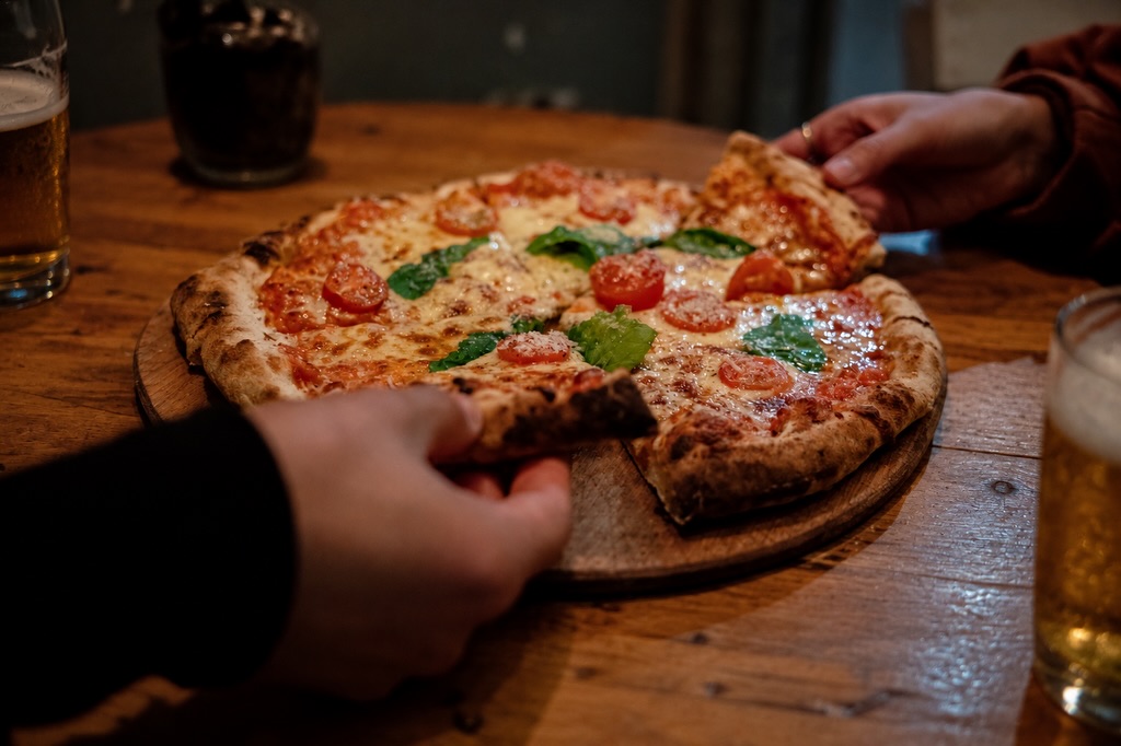 Pizza para compartir en una mesa de Cantina Charrúa